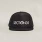 ATHL3TIC5 Flat Bill Foam Trucker Hat by Otto - Black